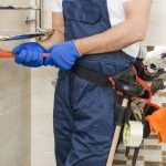 cropplumberusingwrench Az Express Plumbing Plumber using a wrench to repair a pipe