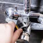 plumber fixes nut of shower faucet close up Az Express Plumbing Expert leak repair service in San Tan Valley AZ