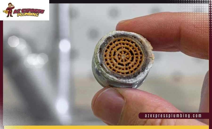 Clogged faucet aerator with mineral buildup restricting water flow