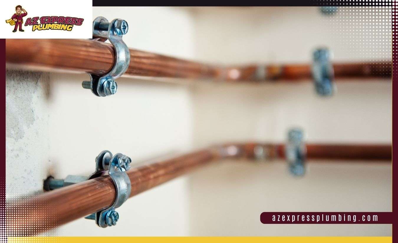 Flexible red and blue PEX plumbing pipes installed alongside rigid copper water supply lines.